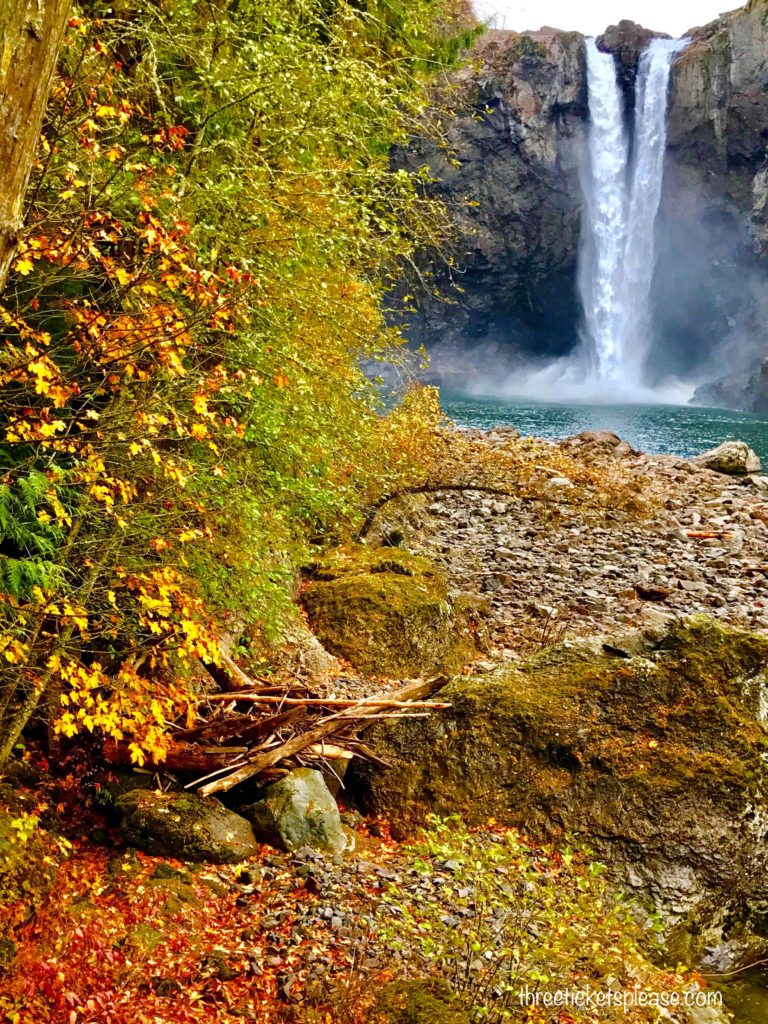 waterfall with orange and yellow leaves around - top places to see fall colors in Seattle