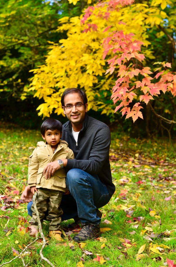 father and son with orange leaves - top places to see fall colors in Seattle